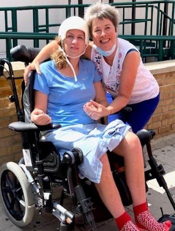 Alice in a wheelchair and her mum